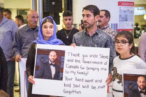 JUSTIN SAMANSKI-LANGILLE / WINNIPEG FREE PRESS
12 year-old Emad Mishko Tamo's mother, Nofa Mihlo Rafo and uncle Hadji Tamo are seen holding a sign early Thursday morning at Winnipeg James Armstrong Richardson International Airport. Tamo was held captive by ISIS and is now re-united with his mother and uncle in Winnipeg.
170817 - Thursday, August 17, 2017.