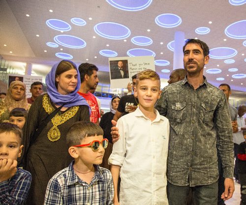JUSTIN SAMANSKI-LANGILLE / WINNIPEG FREE PRESS
Emad Mishko Tamo, 12, centre, his mother Nofa Mihlo Rafo, left, and uncle Hadji Tamo move through a large crowd of supporters and media at Winnipeg's James Armstrong Richardson International Airport Thursday after being re-united.
170817 - Thursday, August 17, 2017.