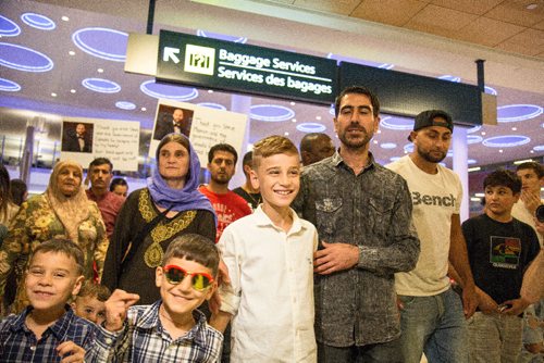 JUSTIN SAMANSKI-LANGILLE / WINNIPEG FREE PRESS
Emad Mishko Tamo, 12, centre, his mother Nofa Mihlo Rafo, left, and uncle Hadji Tamo move through a large crowd of supporters and media at Winnipeg's James Armstrong Richardson International Airport Thursday after being re-united.
170817 - Thursday, August 17, 2017.