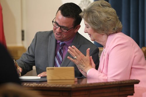 RUTH / BONNEVILLE WINNIPEG FREE PRESS

Jeff Wharton (MLA for Gimli) signs documents with Lieutenant Governor Janice Filmon after he is sworn into cabinet as the new minister of municipal relations during Premier Brian Pallister's  cabinet shuffle  announced  at the Manitoba Legislature Thursday. 

Aug 17, 2017
