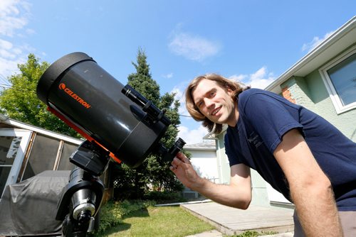 JUSTIN SAMANSKI-LANGILLE / WINNIPEG FREE PRESS
Brenden Petracek, president of the Winnipeg chapter of the Royal Astronomical Society of Canada poses with one of his telescopes Thursday. 
170817 - Thursday, August 17, 2017.