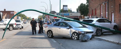 WAYNE GLOWACKI / WINNIPEG FREE PRESS

Winnipeg Police at a multi-vehicle crash on Arlington St. near Prichard Ave. Friday morning. Witnesses say the Police were in pursuit of the vehicle in the foreground traveling westbound on Prichard Ave at aprox. 9AM. where it hit at least two parked vehicles and then collided with two more vehicles on Arlington St. One vehicle  knocked out the light standard and hit the wall of Pinkys Laundromat. One of the two female occupants of the vehicle in pursuit was taken away by ambulance and other was taken into custody.  August 18 2017
