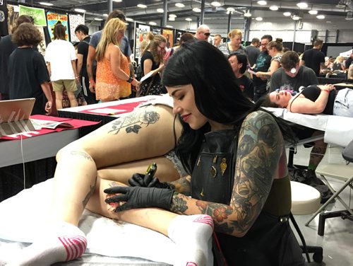 RUTH / BONNEVILLE WINNIPEG FREE PRESS

Tattooer Sam Smith works on a tattoo on the back of a clients leg at the inaugural Winnipeg Tattoo Convention Saturday, on all weekend,  at Red River Exhibition Park. The three-day event is billed as a "celebration of tattoo art, culture, craftsmanship and self-expression and features more than 200 artists.
Standup photo 
Aug 19, 2017