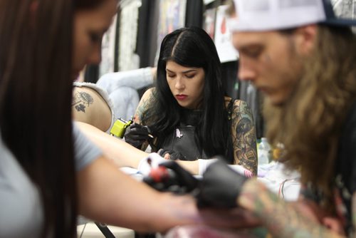 RUTH / BONNEVILLE WINNIPEG FREE PRESS

Tattooer Sam Smith works on a tattoo on the back of a clients leg at the inaugural Winnipeg Tattoo Convention Saturday, on all weekend,  at Red River Exhibition Park. The three-day event is billed as a "celebration of tattoo art, culture, craftsmanship and self-expression and features more than 200 artists.
Standup 

Aug 19, 2017