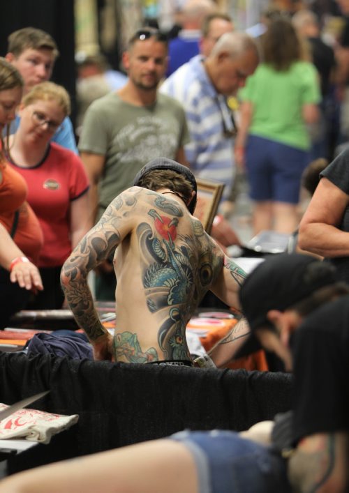 Ruth Bonneville / Winnipeg Free Press 


A guy shows off his tattoos to friends and artists at the inaugural Winnipeg Tattoo Convention Saturday, on all weekend,  at Red River Exhibition Park. The three-day event is billed as a "celebration of tattoo art, culture, craftsmanship and self-expression and features more than 200 artists.
Standup photo 
Aug 19, 2017