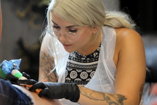 Ruth Bonneville / Winnipeg Free Press 


Tattooer Jennah Bullaro works on a Pokeman tattoo on a women's leg  at the inaugural Winnipeg Tattoo Convention Saturday, on all weekend,  at Red River Exhibition Park. The three-day event is billed as a "celebration of tattoo art, culture, craftsmanship and self-expression and features more than 200 artists.
For Randy's story running Monday, Aug 21st.  
Aug 19, 2017