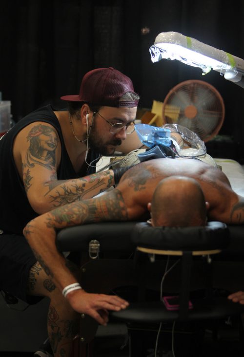 Ruth Bonneville / Winnipeg Free Press


Tattooer Derek Joyce (DJ) from Warlock Tattoo studio in Brandon, , works on a tattoo on the back of Mike Branconnier at the inaugural Winnipeg Tattoo Convention Saturday, on all weekend,  at Red River Exhibition Park. The three-day event is billed as a "celebration of tattoo art, culture, craftsmanship and self-expression and features more than 200 artists.
For Randy Turner's story to run Monday.  
Aug 19, 2017