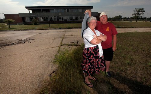 PHIL HOSSACK / WINNIPEG FREE PRESS  - Gord and Jacki Little pose in front of the Enlisted men's Mess on the former CFB Kapyong, about 25 vets came "home" for a last look at the soon to be demolished former Military base. The couple met at a dance there 0ver 30 years ago. See Melissa Martin story. - August 21, 2017