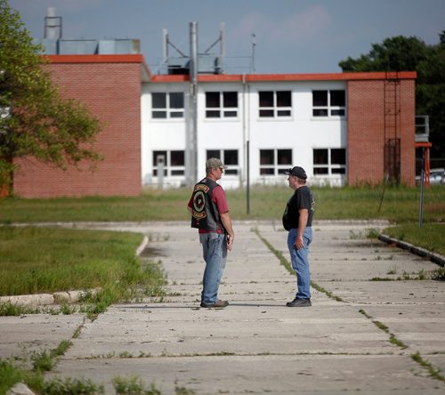 PHIL HOSSACK / WINNIPEG FREE PRESS  - Two veterans  remember old tales with Kapyong's regimental headquarter building behind them, formerly based here about 25 vets came "home" for a last look at the soon to be demolished former Military base. See Melissa Martin story. - August 21, 2017