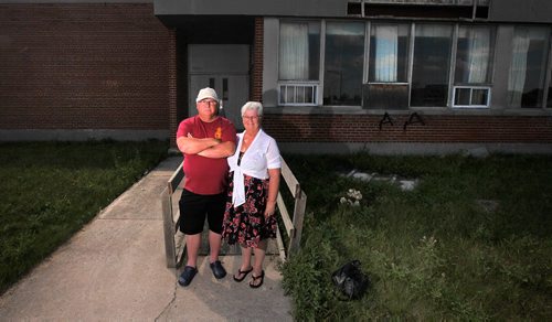 PHIL HOSSACK / WINNIPEG FREE PRESS  - Gord and Jacki Little pose in front of the Enlisted men's Mess on the former CFB Kapyong, about 25 vets came "home" for a last look at the soon to be demolished former Military base. The couple met at a dance there 0ver 30 years ago. See Melissa Martin story. - August 21, 2017