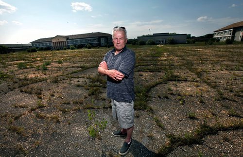PHIL HOSSACK / WINNIPEG FREE PRESS  - Ed Bonin poses in the centre of the parade ground at the former Kapyong Barracks. He remebers "policing" the grounds in a row of soldiers picking up cigarette buts and trash by hand.   About 25 vets came "home" for a last look at the soon to be demolished former Military base. None of the vets were allowed into the bases buildings. See Melissa Martin story. - August 21, 2017