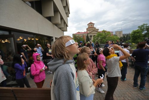Ruth Bonneville  /  Winnipeg Free Press

Ben Bernhardt (11yrs), catches a glimpse of the partial solar eclipse that poked through the clouds  while he was with his family and others that gathered at DEGREES Restaurant at University Centre at the U of M  for their Solar Eclipse viewing party Monday.  



Aug 21, 2017