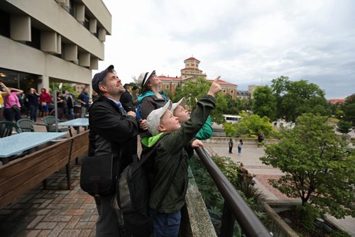 Ruth Bonneville  /  Winnipeg Free Press

A family try to catch a glimpse of the partial solar eclipse through the clouds  while gathered at DEGREES Restaurant at University Centre at the U of M  for their Solar Eclipse viewing party Monday.  



Aug 21, 2017