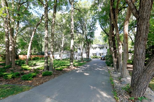 JUSTIN SAMANSKI-LANGILLE / WINNIPEG FREE PRESS
The front yard of 59 Salme includes a large lawn, driveway and two car garage.
170822 - Tuesday, August 22, 2017.