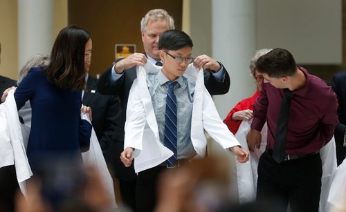 WAYNE GLOWACKI / WINNIPEG FREE PRESS

 In centre, Henry Li, 19, receives his coat from Dr. Brock Wright, pres. & CEO Shared Health Services Manitoba at the White Coat Ceremony on Wednesday at the University of Manitobas Bannatyne Campus. Henry was one of the 110 students of the Class of 2021 that were formally cloaked in their first white coats as part of Inaugural Exercises at the Max Rady College of Medicine in the Rady Faculty of Health Sciences.  Jane Gerster story   August 23 2017