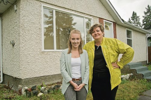Canstar Community News Aug. 23, 2017 - South Winnipeg-St. Norbert city councillor Janice Lukes (right) poses with summer intern Hailey Hooke outside of a suspected rooming house on Grierson Avenue in Fort Richmond. The two are working on creating an inventory of illegal rooming houses in the neighbourhood and are compiling data to help curb the conversion of single family homes to rental revenue properties. (DANIELLE DA SILVA/CANSTAR/SOUWESTER)