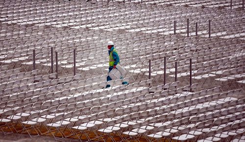 PHIL HOSSACK / WINNIPEG FREE PRESS  -  A laborer sets up chairs as the Guns n' Roses stage rises in the Investor's Group Field Wednesday afternoon. One of three, the stage takes three days to build and thirty trucks to transport it and the pyrotechnics and gear associated with the world tour. Up to 1100 local people are often hired at each stop, from paramedics to cooks to laborers.  - August 23, 2017