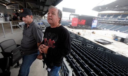 PHIL HOSSACK / WINNIPEG FREE PRESS  -  Ron Chamberlain (left) and Ken Craig, Guns n' Roses Production Managers hold a brief press conference as the Guns n' Roses stage rises in the Investor's Group Field Wednesday afternoon. One of three, the stage takes three days to build and thirty trucks to transport it and the pyrotechnics and gear associated with the world tour. Up to 1100 local people are often hired at each stop, from paramedics to cooks to laborers.  - August 23, 2017