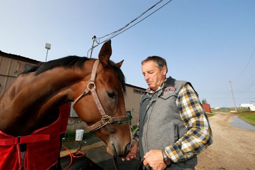 JUSTIN SAMANSKI-LANGILLE / WINNIPEG FREE PRESS
Racehorse Escape Clause and trainer Don Schnell pose in front of the Assiniboia Downs stables Thursday.
170824 - Thursday, August 24, 2017.
