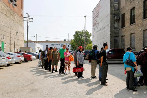 JUSTIN SAMANSKI-LANGILLE / WINNIPEG FREE PRESS
Guests line up Thursday at the Siloam Mission 30th Anniversary Block Party.
170824 - Thursday, August 24, 2017.