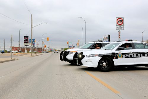 JUSTIN SAMANSKI-LANGILLE / WINNIPEG FREE PRESS
Winnipeg Police vehicles block traffic on Logan Saturday. Police say a cyclist was hit by a vehicle near the intersection of Logan and Arlington before 11am.
170826 - Saturday, August 26, 2017.