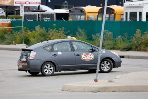 JUSTIN SAMANSKI-LANGILLE / WINNIPEG FREE PRESS
A taxi sits inside a police scene near the intersection of Arlington and Logan Saturday. Police say a cyclist was hit by a vehicle near the intersection of Logan and Arlington before 11am.
170826 - Saturday, August 26, 2017.
