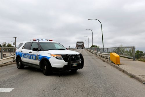 JUSTIN SAMANSKI-LANGILLE / WINNIPEG FREE PRESS
A Winnipeg Auxiliary Cadets vehicle blocks traffic from entering the North end of the Arlington Bridge Saturday. Police say a cyclist was hit by a vehicle near the intersection of Logan and Arlington before 11am.
170826 - Saturday, August 26, 2017.
