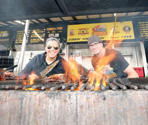 JUSTIN SAMANSKI-LANGILLE / WINNIPEG FREE PRESS
Freddy Kefalidis (L) and Derek Portier of Crabby's BBQ Shack grill up some ribs Saturday during Winnipeg Ribfest at The Forks.
170826 - Saturday, August 26, 2017.