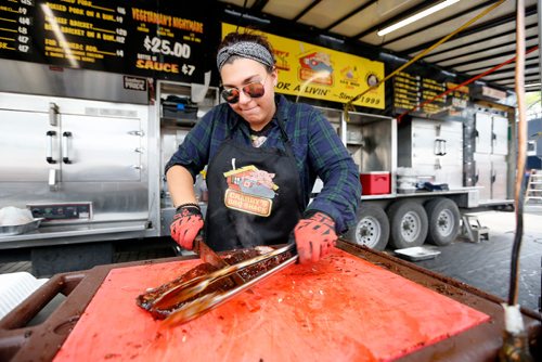 JUSTIN SAMANSKI-LANGILLE / WINNIPEG FREE PRESS
Freddy Kefalidis prepares some ribs Saturday during Winnipeg Ribfest at The Forks.
170826 - Saturday, August 26, 2017.