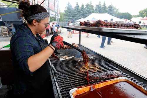 JUSTIN SAMANSKI-LANGILLE / WINNIPEG FREE PRESS
Freddy Kefalidis grills some ribs Saturday during Winnipeg Ribfest at The Forks.
170826 - Saturday, August 26, 2017.