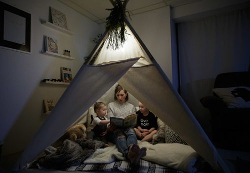 MIKE DEAL / WINNIPEG FREE PRESS
Jennifer Robins owner of the homebased Kate & Norah Co. sit's in a lavvu (that's pronounced la-VOO) with her children, Kate and Norah. The lavvu is a Scandinavian-style tent and were originally used by deer herders in the high Arctic. Hers are geared more towards children and are generally used as play areas at home, in the backyard or on the beach. 
170828 - Monday, August 28, 2017.