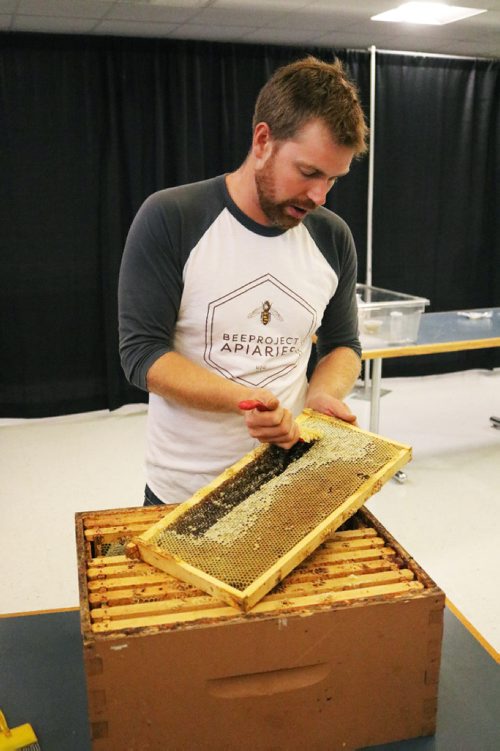 Canstar Community News Aug. 23, 2017 - Chris Kirouac, co-founder of Beeproject Apiaries, demonstrates how to extract honey from an urban hive at Red River Colleges Notre Dame Campus. (Ligia Braidotti/Canstar Community News/The Times)