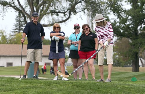 JASON HALSTEAD / WINNIPEG FREE PRESS

Golfer Linda Ames tees off with a hockey stick after spinning the wheel to see what she'd tee off with during the Winnipeg Harvest Charity Golf Tournament at St. Boniface Golf Club on Aug. 28, 2017. (See Social Page)