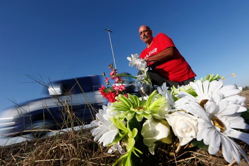 JOHN WOODS / WINNIPEG FREE PRESS
Larry Saunders, a concerned citizen and MVC witness, is photographed beside a memorial at the intersection of highway 1 and 16 west of Portage La Prairie Monday, August 28, 2017. People are calling for an overpass at the intersection after several deaths recently.