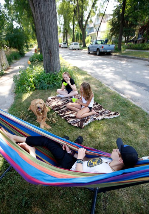 WAYNE GLOWACKI / WINNIPEG FREE PRESS

Kieran relaxes in the hammock with Gabby,right, Darby and Coco the dog enjoy the shade along Chestnut St. in Wolseley Tuesday afternoon. weather  story  August 29 2017