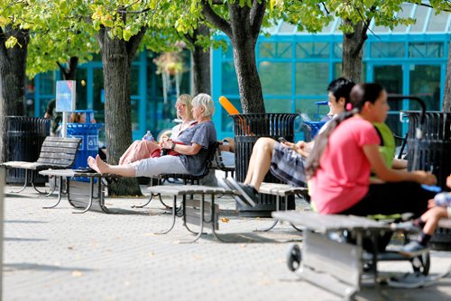 JUSTIN SAMANSKI-LANGILLE / WINNIPEG FREE PRESS
People relax and enjoy the beautiful weather Tuesday on a row of benches at The Forks.
170829 - Tuesday, August 29, 2017.