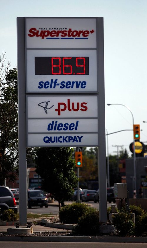PHIL HOSSACK / WINNIPEG FREE PRESS  - Motorists line up at a St Annes Rd. Superstore gas bar taking advantage of the still lower price for fuel (86.9cents/litre) The Co-op Gas bar across the street was already up at 99.9 cents/litre) - See story. - August 29, 2017