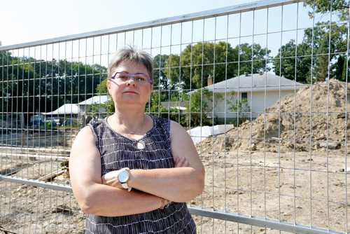 JUSTIN SAMANSKI-LANGILLE / WINNIPEG FREE PRESS
Janice Klassen poses Wednesday in front of the construction site of two personal care facilities across the street from her home. Klassen says city hall allowed the construction to start without requiring to give notice to residents of the area.
170830 - Wednesday, August 30, 2017.