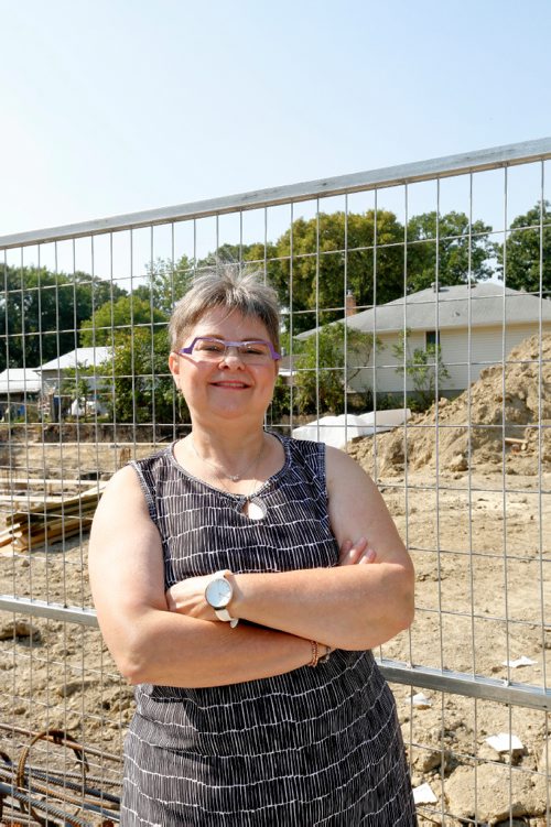 JUSTIN SAMANSKI-LANGILLE / WINNIPEG FREE PRESS
Janice Klassen poses Wednesday in front of the construction site of two personal care facilities across the street from her home. Klassen says city hall allowed the construction to start without requiring to give notice to residents of the area.
170830 - Wednesday, August 30, 2017.