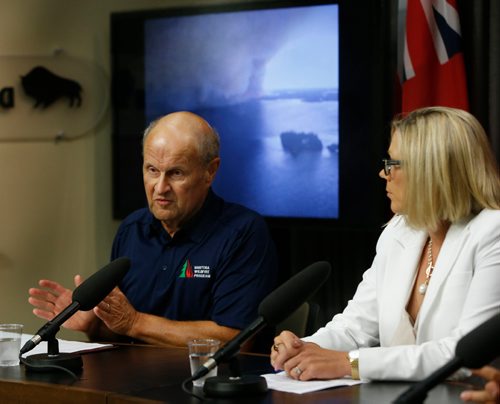 WAYNE GLOWACKI / WINNIPEG FREE PRESS

At right, Sustainable Development Minister Rochelle Squires and Gary Friesen, manager, fire program, Manitoba Sustainable Development at the news conference in the Legislative building Wednesday to update wildfire response efforts in Island Lake area. In back is a recent photo of fire Island Lakes area. Nick Martin story  August 30 2017