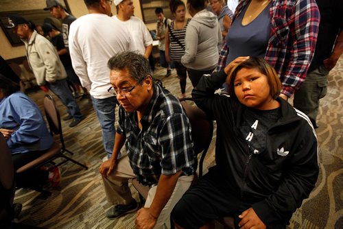 PHIL HOSSACK / WINNIPEG FREE PRESS  -  left to right, Garden Hill  residents Lloyd Little and 13yr old Shem Flett wait at a Red Cross reception area at Canad Inns Polo Park for refugees fleeing norther fires in Manitoba Wednesday. See story - August 30, 2017