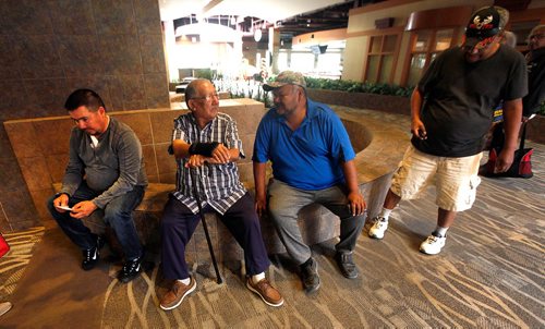 PHIL HOSSACK / WINNIPEG FREE PRESS  -  left to right, Garden Hill  Chief Dino Flett, counselor's Russell Harper and Robert Little (sitting) wait for community members flying into Winnipeg arriving at a Red Cross reception area at Canad Inns Polo Park for refugees fleeing norther fires in Manitoba Wednesday. See story - August 30, 2017