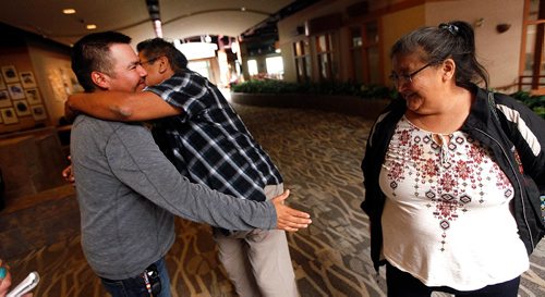PHIL HOSSACK / WINNIPEG FREE PRESS  -  Garden Hill  Chief Dino Flett, (left) welcomes Lloyd and Margaret Little at a Red Cross reception area at Canad Inns Polo Park for refugees fleeing norther fires in Manitoba Wednesday. See story - August 30, 2017