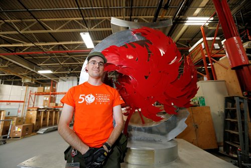 JUSTIN SAMANSKI-LANGILLE / WINNIPEG FREE PRESS
Hugh Campbell poses with the Canada Games cauldron Wednesday inside a warehouse containing all of the surplus equipment from the Canada Games. Many of the items are being auctioned off and the rest are being shipped off to Alberta to be re-used for the next games.
170830 - Wednesday, August 30, 2017.