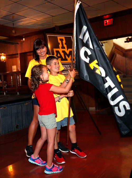 WAYNE GLOWACKI / WINNIPEG FREE PRESS

Dr. Sarah Dentry former Team Canada competitor and a Invictus Games 2017 Flagbearer with her children Loki and Saskia,left, hold the Invictus Games National Flag as it arrives at the St. James Legion on Portage Ave. Wednesday.  The flag tour is traveling from coast-to-coast and will visit 22 Canadian Armed Forces, 15 legions and over 50 communities, from August 16th to September 22nd. The Invictus Games use the power of adaptive sport to help wounded warriors on their journey to recovery, the Invictus Games Toronto 2017 takes place September 23rd to September 30th. Established by Prince Harry, the inaugural Invictus Games took place in London in September 2014. There will be 556 competitors from 17 allied nations taking part in this years games.August 30 2017
