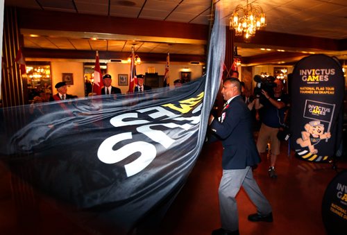 WAYNE GLOWACKI / WINNIPEG FREE PRESS

Keith Muffty, executive with the St. James Legion waves the Invictus Games National Flag as it arrives at Legion on Portage Ave. Wednesday. Keith was the official Flagbearer in the legion, he received it from Dr. Sarah Dentry. The flag tour is traveling from coast-to-coast and will visit 22 Canadian Armed Forces, 15 legions and over 50 communities, from August 16th to September 22nd. The Invictus Games use the power of adaptive sport to help wounded warriors on their journey to recovery, the Invictus Games Toronto 2017 takes place September 23rd to September 30th. Established by Prince Harry, the inaugural Invictus Games took place in London in September 2014. There will be 556 competitors from 17 allied nations taking part in this years games. August 30 2017