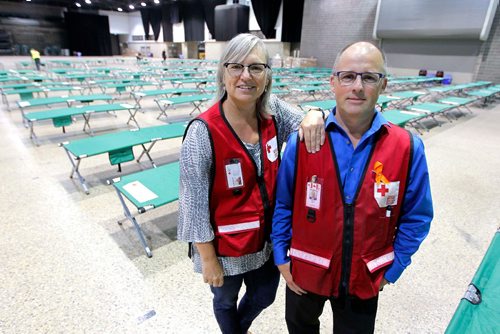 BORIS MINKEVICH / WINNIPEG FREE PRESS
From left, Red Cross' Kimberly MacLean and Shawn Feely, vice president of the Canadian Red Cross for the Manitoba and Nunavut regions in front of cots in the RBC Convention Centre. The first bus loads of forest fire evacuees from Garden Hill northern MB arrived at the RBC Convention Centre this morning. BEN WALDMAN STORY. August 31, 2017