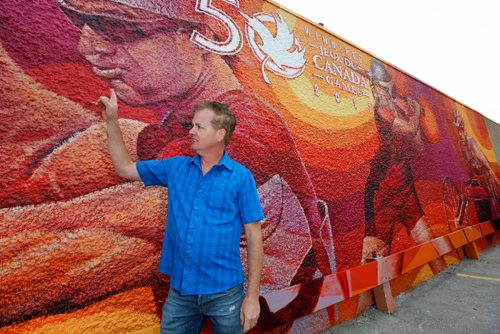 JUSTIN SAMANSKI-LANGILLE / WINNIPEG FREE PRESS
Local artist Charlie Johnson poses next to his new mural, inspired by the 2017 Canada Games Thursday.
170831 - Thursday, August 31, 2017.