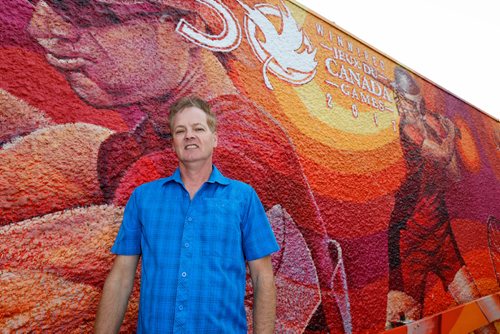 JUSTIN SAMANSKI-LANGILLE / WINNIPEG FREE PRESS
Local artist Charlie Johnson poses next to his new mural, inspired by the 2017 Canada Games Thursday.
170831 - Thursday, August 31, 2017.