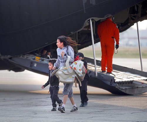 PHIL HOSSACK / WINNIPEG FREE PRESS  - A Northern Manitoba fire evacuee and her children step off of a Canadian Forces C130 Herculese transport arrives at James Richardson International Airport in Winnipeg Ferrying northern Manitoba fire evacuees south to shelter.- August 30, 2017
